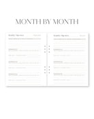 Two-page spread of a planner with 'Month by Month' at the top.